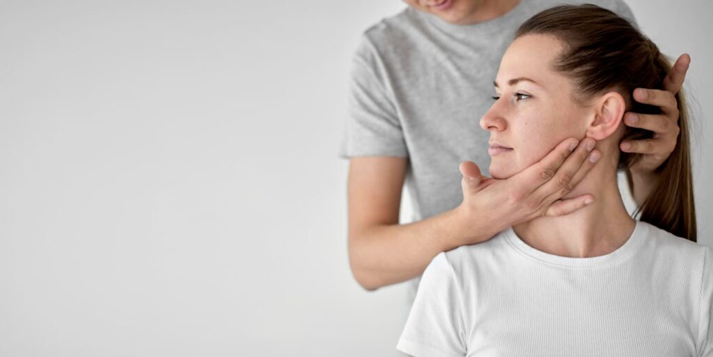 terapeuta realizando masaje en cuello de paciente con fondo blanco